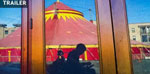 silhouette off a wheelchair user moving in front of a circus tent