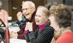 Photo of 3 older adults laughing together