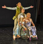 Three dancers, one using a wheelchair