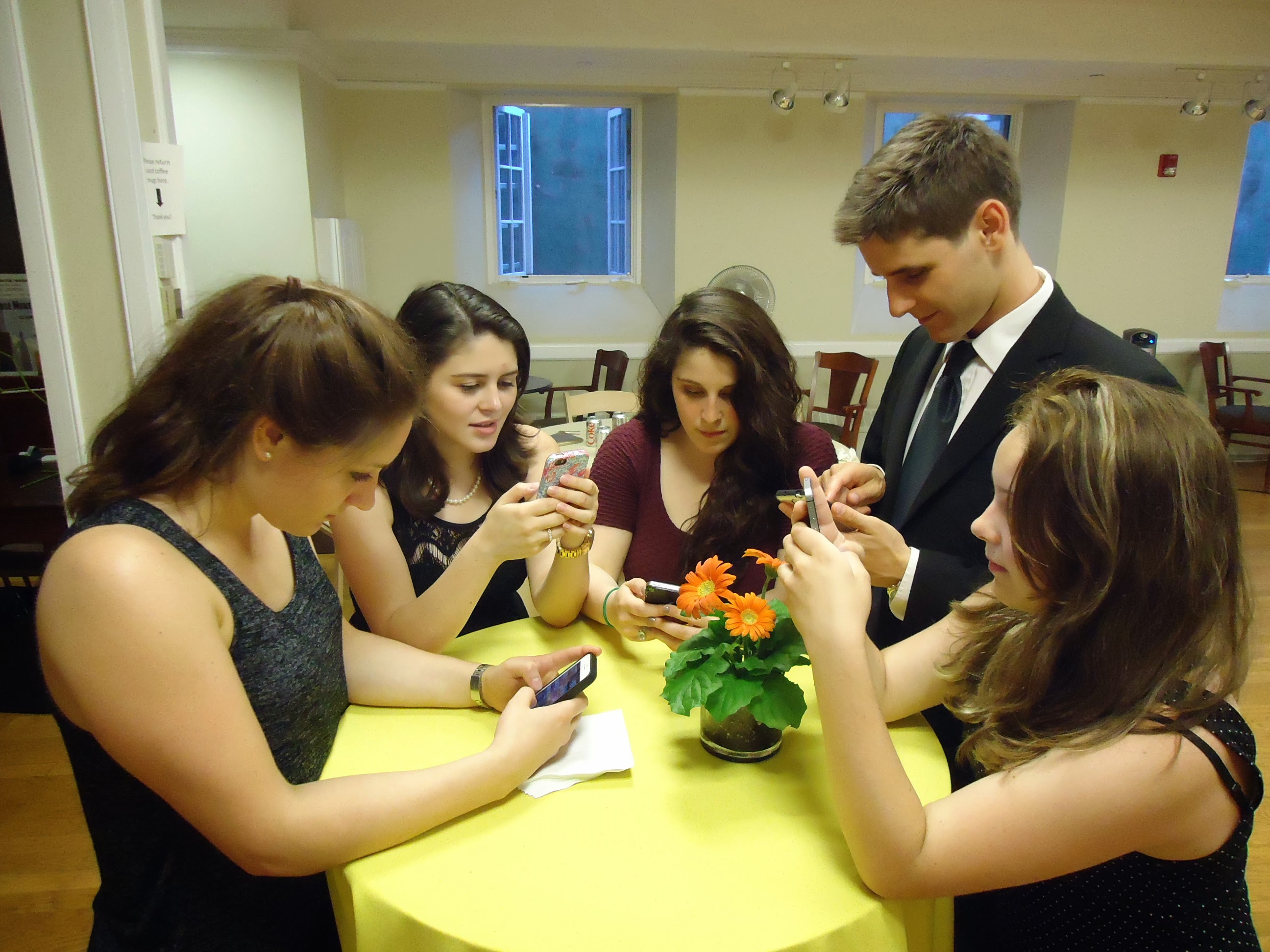 Young people with smartphones texting
                at a party. Licensed under Creative Commons from
https://en.wikipedia.org/wiki/Digitality#/media/File:Young_people_texting_on_smartphones_using_thumbs.JPG