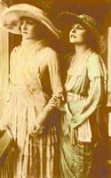 Standing portrait of Norma and Constance Talmadge in Lucile gowns