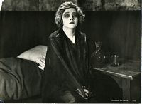 Film still from Madame X, Frederick in makeup seated