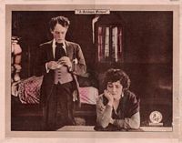 Film still from Madame X, Frederick and man at desk in seedy apartment