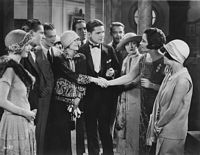 Film still from Smouldering Fires, with Frederick, Malcolm McGregor, Laura LaPlante, and others